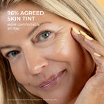 Close-up of a woman with a skin tint swatch on her cheek, illustrating lightweight radiant coverage. Independent study found that 96% agreed Skin Tint wore comfortably all day.