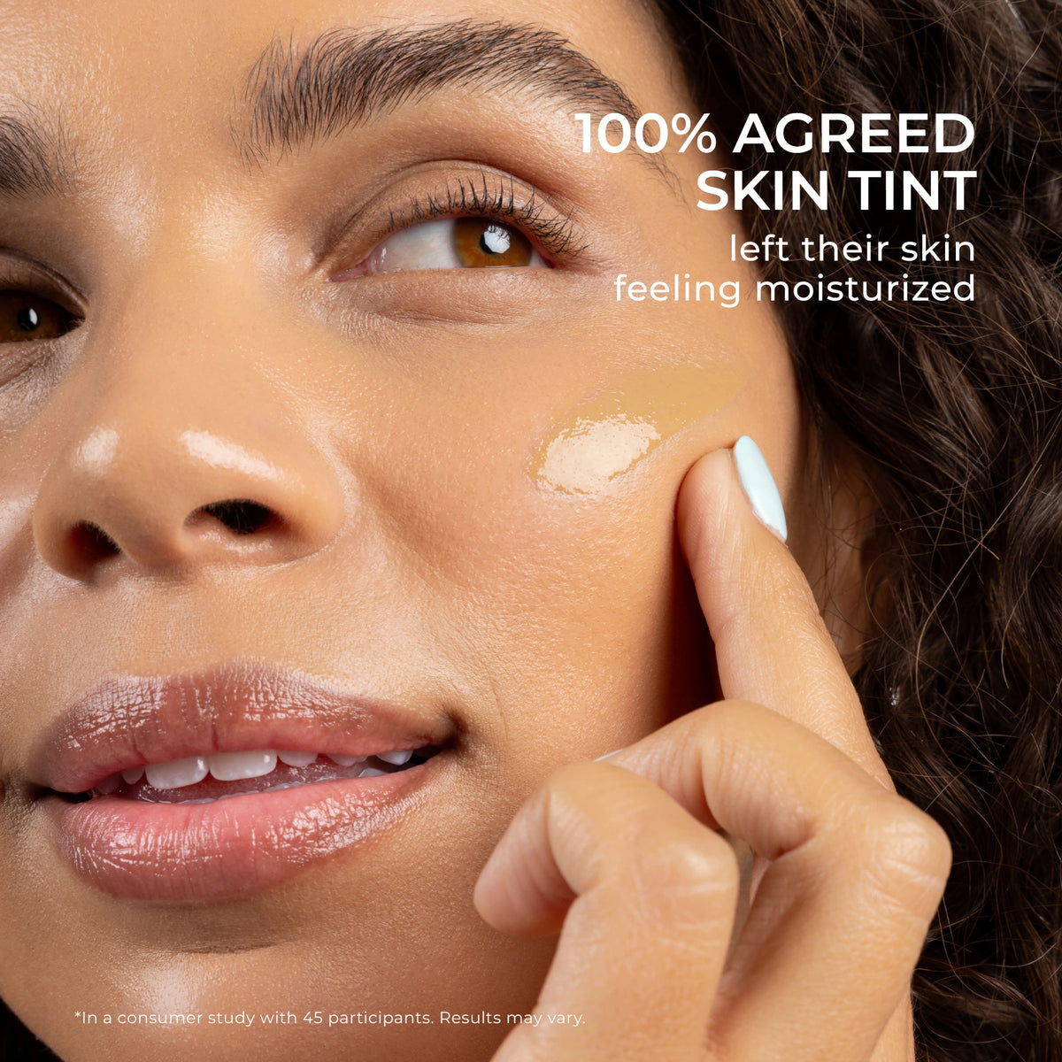 Close-up of a model's face with a dab of 4-in-1 Skin Tint SPF 50 on her cheek, highlighting mineral sunscreen coverage. Independent study found that 100% agreed Skin Tint left their skin feeling moisturized.