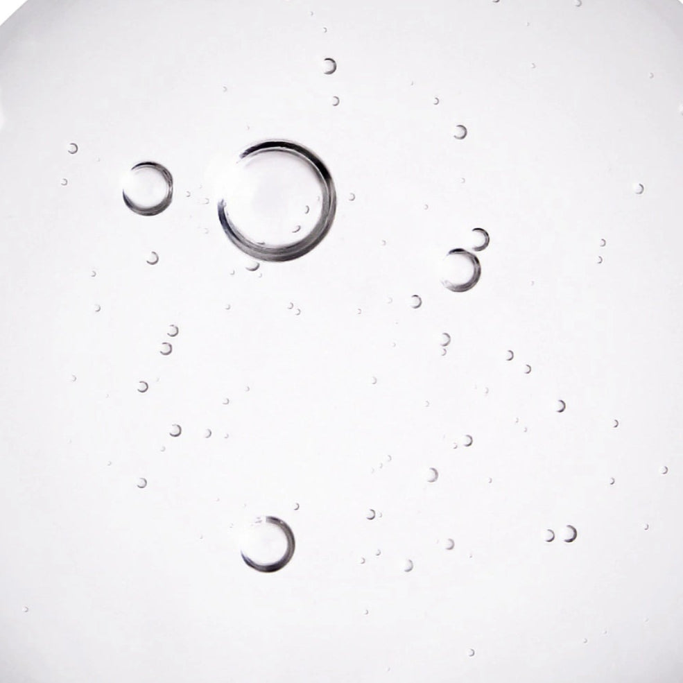Lactic Acid ingredient close up - clear, white liquid with bubbles